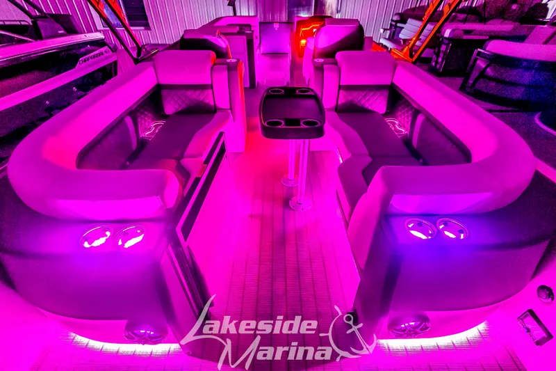 Slide: The Image of Luxurious 2025 Godfrey AquaPatio 255 SBC with vibrant pink LED lighting at Lakeside Marina. - 13