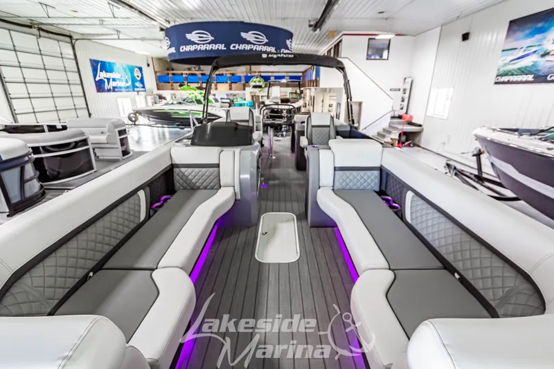 Slide: The Image of 2025 Godfrey AquaPatio 255 SBC pontoon boat interior with modern seating and ambient lighting. - 19