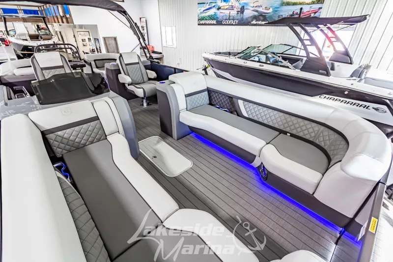Slide: The Image of Luxurious 2025 Godfrey AquaPatio 255 SBC pontoon boat interior with modern seating and ambient lighting. - 20