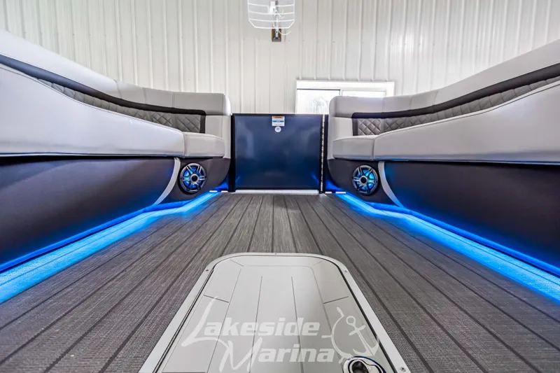Slide: The Image of Interior of 2025 Godfrey AquaPatio 255 SBC with blue LED lighting and sleek seating. - 24