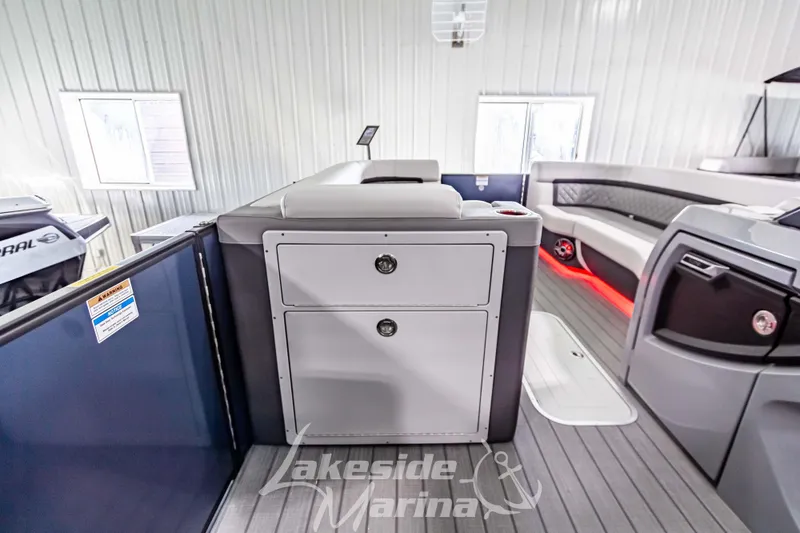 Slide: The Image of Interior of 2025 Godfrey AquaPatio 255 SBC boat with modern seating and storage. - 34