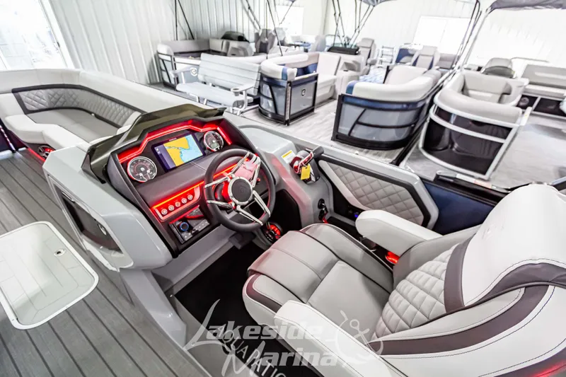 Slide: The Image of 2025 Godfrey AquaPatio 255 SBC boat interior with modern dashboard and seating. - 38