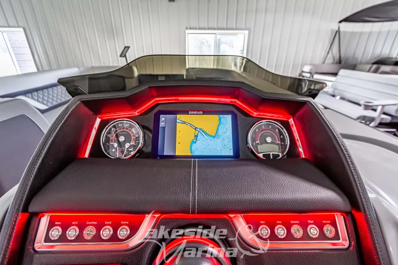 Slide: The Image of Dashboard of 2025 Godfrey AquaPatio 255 SBC with navigation display and illuminated controls. - 39