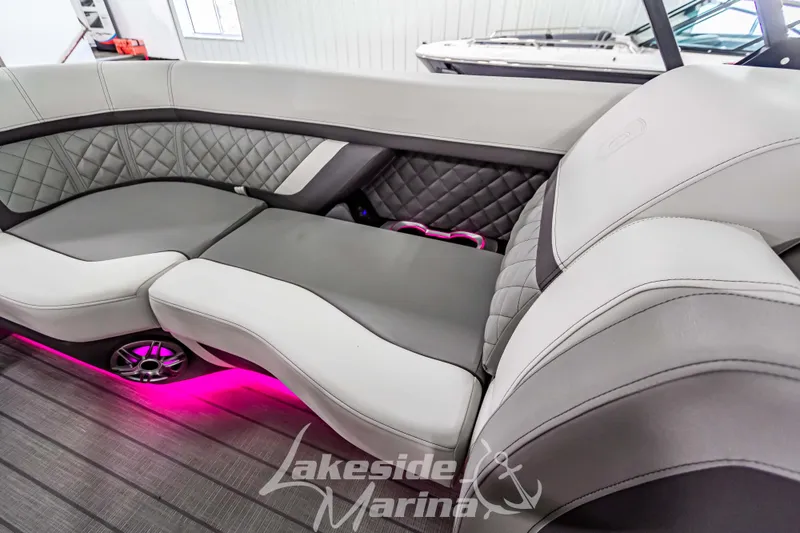 Slide: The Image of Luxurious seating on 2025 Godfrey AquaPatio 255 SBC boat with ambient pink lighting. - 44