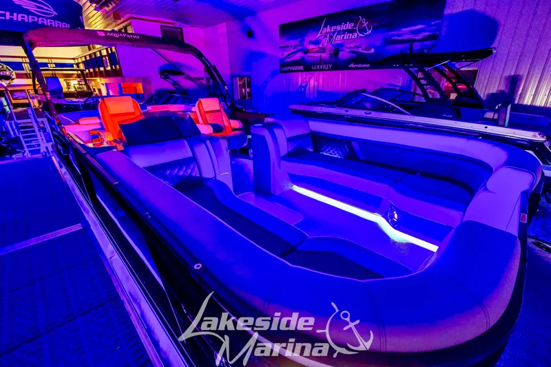 Slide: The Image of 2025 Godfrey AquaPatio 255 SBC boat with vibrant interior lighting at Lakeside Marina. - 5