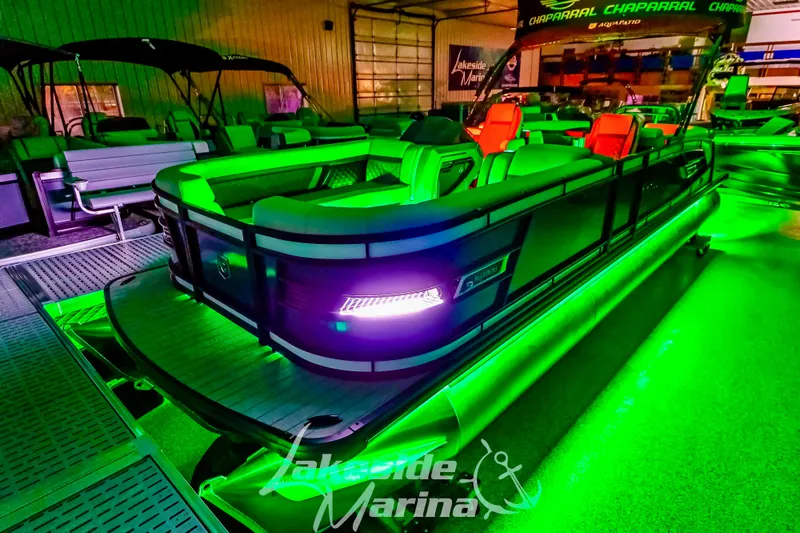 Slide: The Image of 2025 Godfrey AquaPatio 255 SBC boat with vibrant green LED lighting at Lakeside Marina. - 6