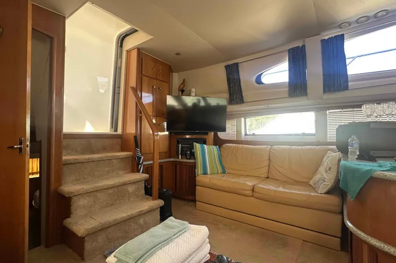 Slide: The Image of Interior of 2001 Carver 396 Motor Yacht with beige sofa and TV. - 16