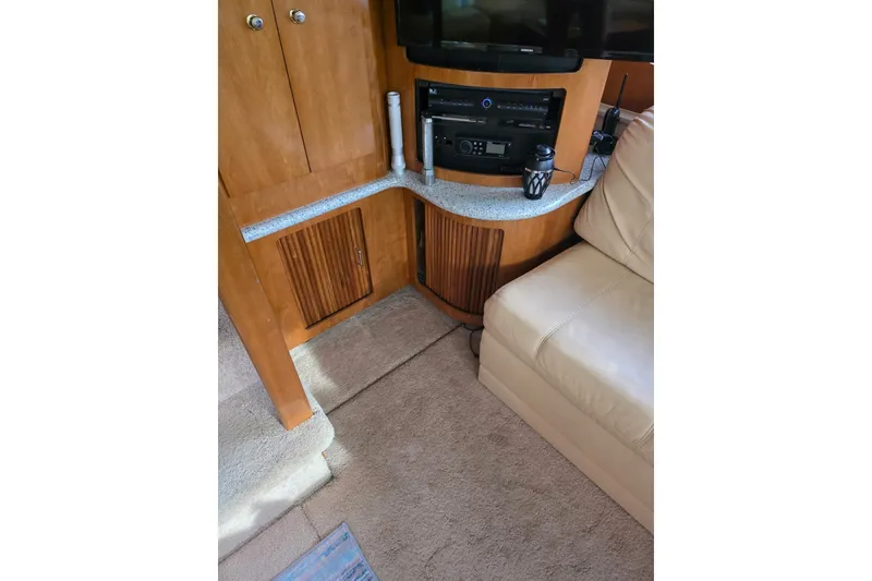 Slide: The Image of Interior of 2001 Carver 396 Motor Yacht with beige seating and wooden cabinetry. - 17