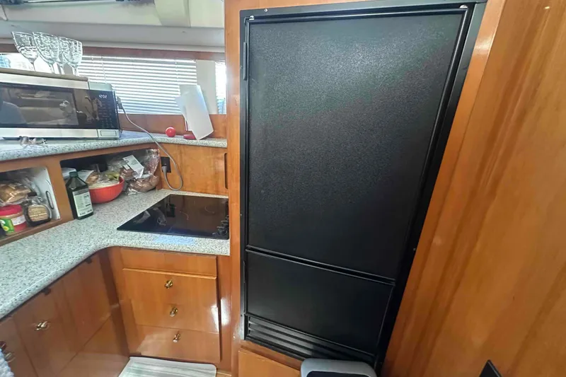 Slide: The Image of Kitchen area of 2001 Carver 396 Motor Yacht with appliances and storage. - 19