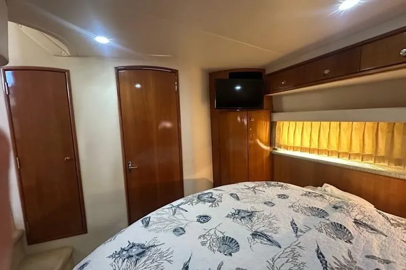 Slide: The Image of Interior of 2001 Carver 396 Motor Yacht with wood paneling and cozy bedding. - 22