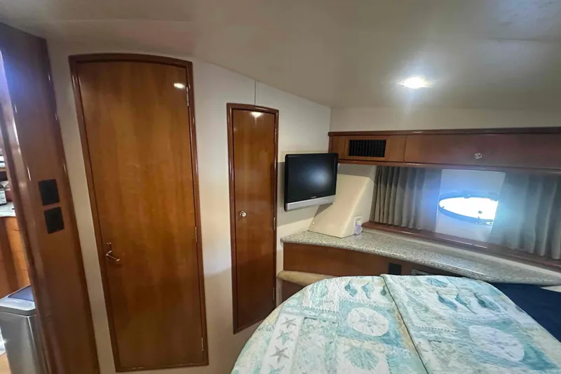 Slide: The Image of Interior of 2001 Carver 396 Motor Yacht with wood paneling and TV. - 26