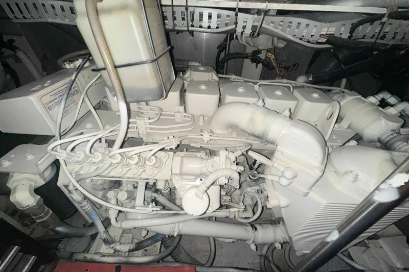 Slide: The Image of Engine compartment of a 2001 Carver 396 Motor Yacht, showcasing mechanical components. - 32