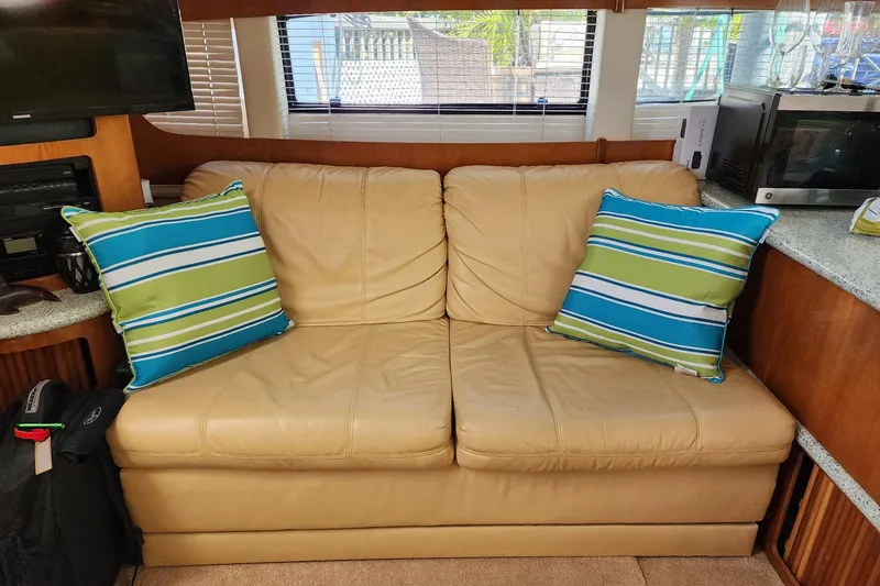 Slide: The Image of Interior of 2001 Carver 396 Motor Yacht with beige sofa and striped pillows. - 15