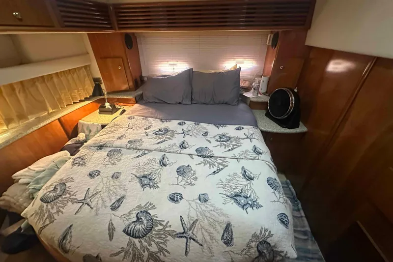 Slide: The Image of Cozy bedroom in 2001 Carver 396 Motor Yacht with seashell-themed bedding. - 21