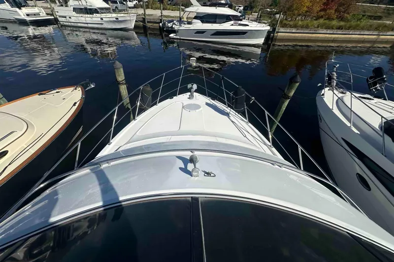 Slide: The Image of 2001 Carver 396 Motor Yacht docked at marina, surrounded by other boats. - 4