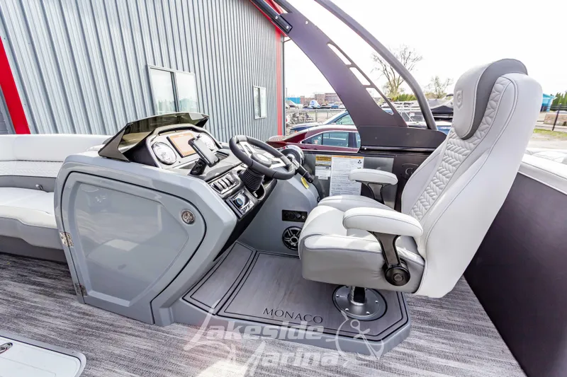 Slide: The Image of 2025 Godfrey Monaco 235 SB boat interior with modern helm and luxurious captain's chair. - 18