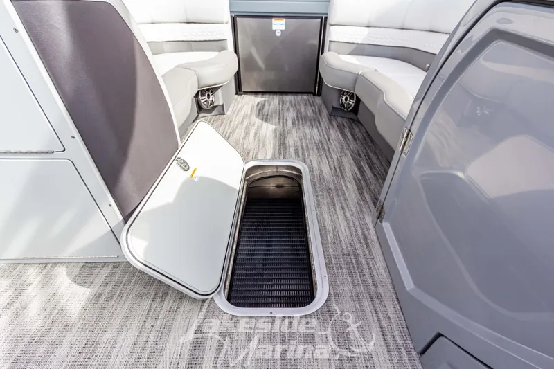 Slide: The Image of 2025 Godfrey Monaco 235 SB interior with open storage compartment and seating area. - 20