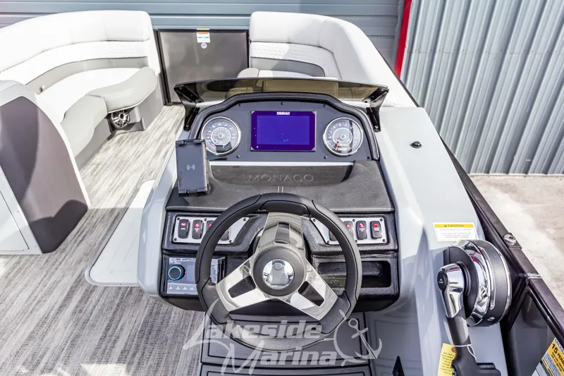 Slide: The Image of Helm of 2025 Godfrey Monaco 235 SB boat with modern controls and seating. - 22