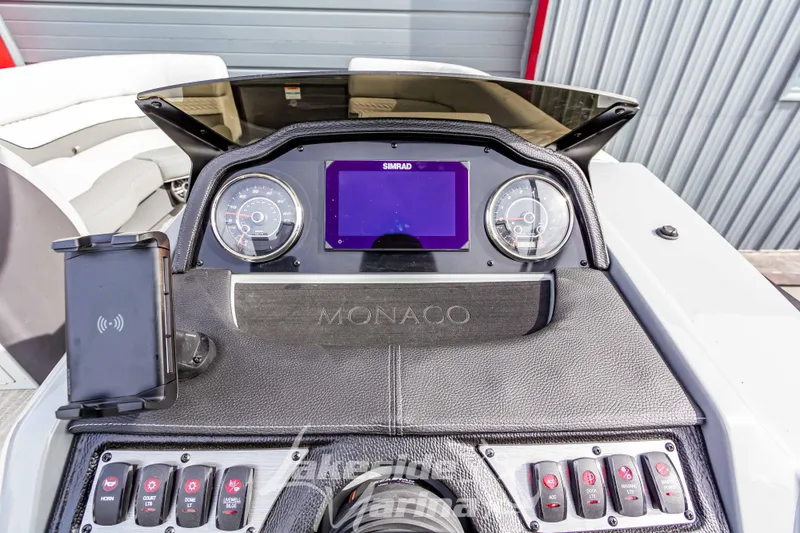 Slide: The Image of 2025 Godfrey Monaco 235 SB dashboard with modern controls and display. - 23