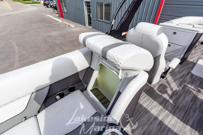 Slide: The Image of 2025 Godfrey Monaco 235 SB boat interior with open storage compartment and seating. - 29