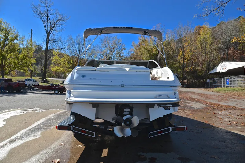 Slide: The Image of 2008 Cobalt 222 boat on trailer, surrounded by autumn trees and clear blue sky. - 13