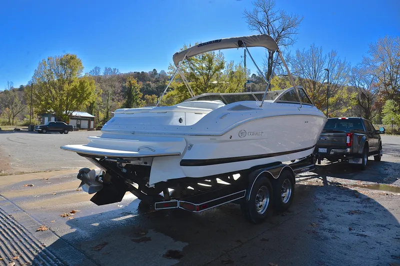 Slide: The Image of 2008 Cobalt 222 boat on trailer, parked outdoors on a sunny day. - 14