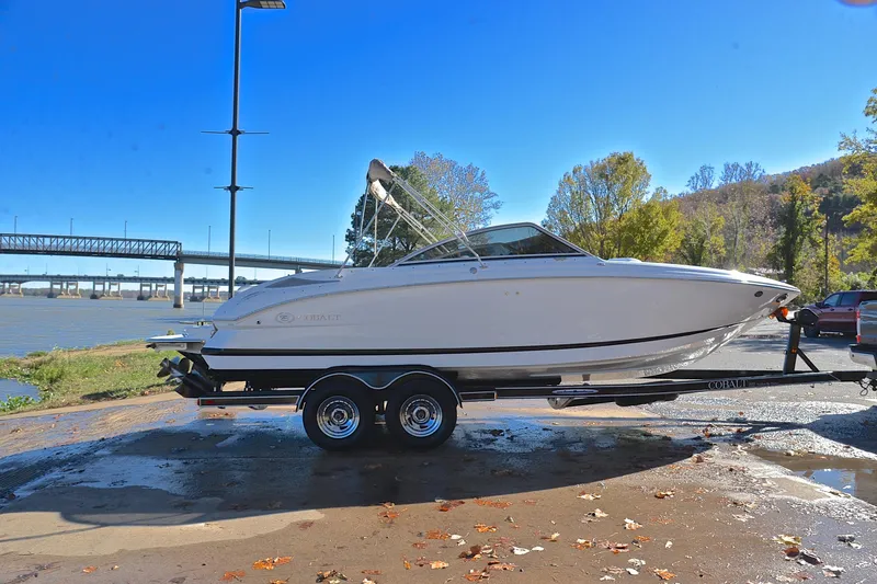 Slide: The Image of 2008 Cobalt 222 boat on trailer by river, clear blue sky background. - 15