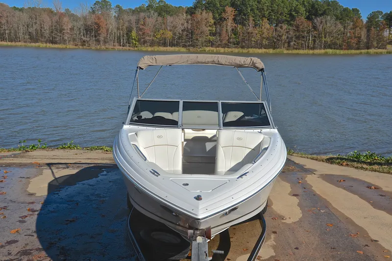 Slide: The Image of 2008 Cobalt 222 boat on a trailer by a lake, surrounded by autumn trees. - 17