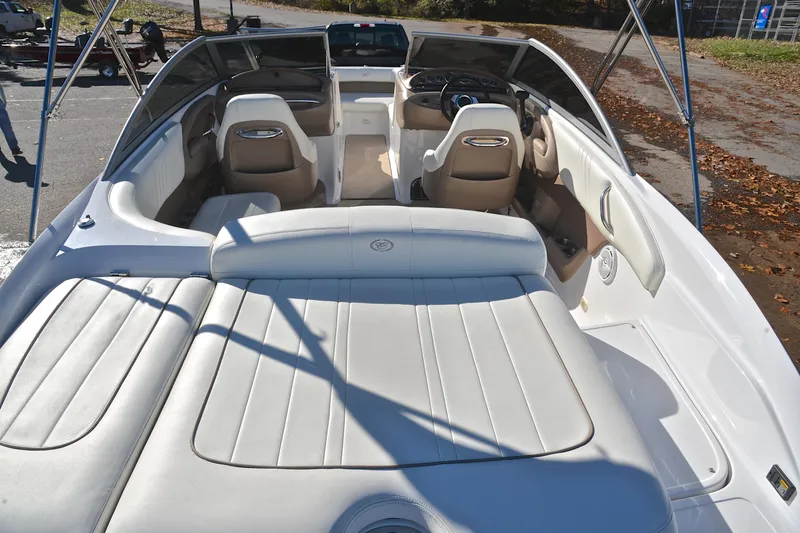 Slide: The Image of 2008 Cobalt 222 boat interior with white and beige seating, showcasing spacious design. - 18