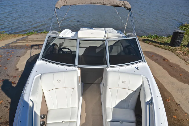 Slide: The Image of 2008 Cobalt 222 boat with white interior, docked by a serene lake. - 20