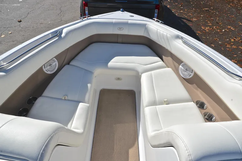 Slide: The Image of Interior of 2008 Cobalt 222 boat with white seating and cup holders. - 21