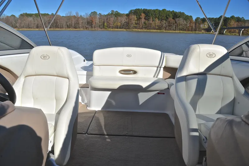 Slide: The Image of Interior of 2008 Cobalt 222 boat with white leather seats on a lake. - 22