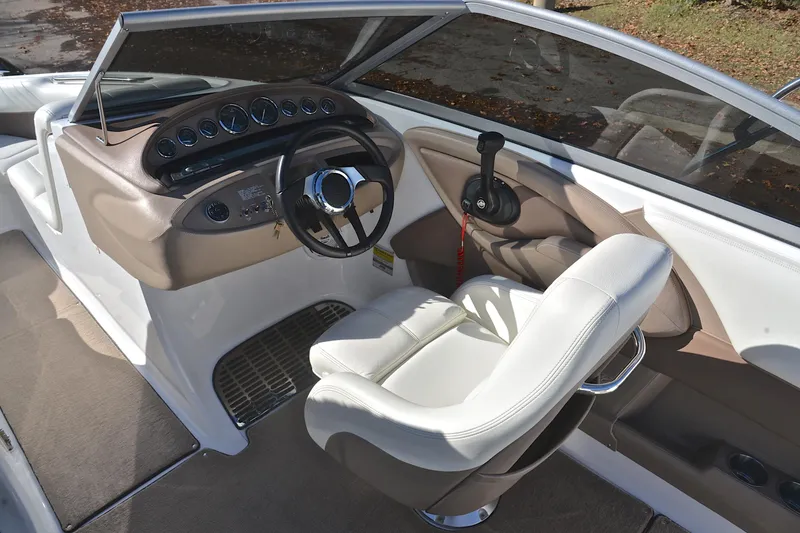 Slide: The Image of Interior of a 2008 Cobalt 222 boat, featuring steering wheel and dashboard controls. - 24