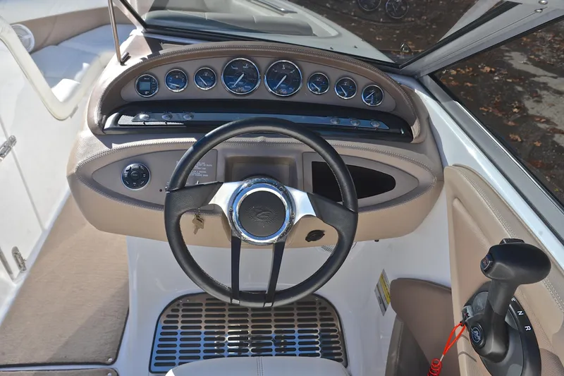 Slide: The Image of Interior dashboard of a 2008 Cobalt 222 boat, featuring steering wheel and control panel. - 25