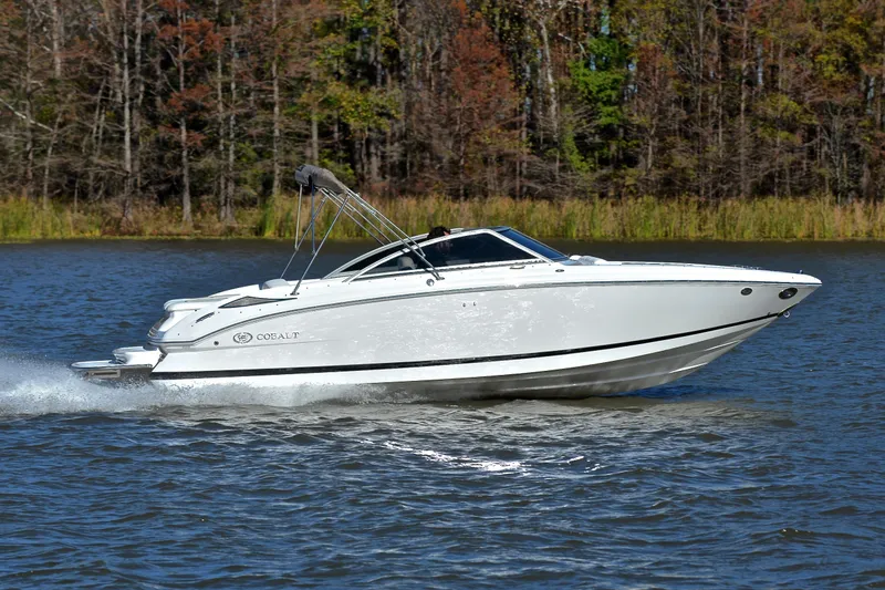 Slide: The Image of 2008 Cobalt 222 boat cruising on a lake with forested background. - 3