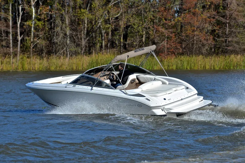 Slide: The Image of 2008 Cobalt 222 boat cruising on a lake with trees in the background. - 6