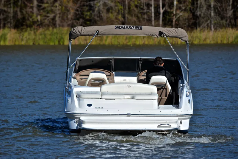 Slide: The Image of 2008 Cobalt 222 boat cruising on a lake with a canopy and seating. - 8