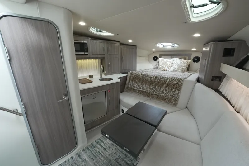 Slide: The Image of Luxurious interior cabin of 2021 Regal 33 XO yacht with cozy bedding and ambient lighting. - 17