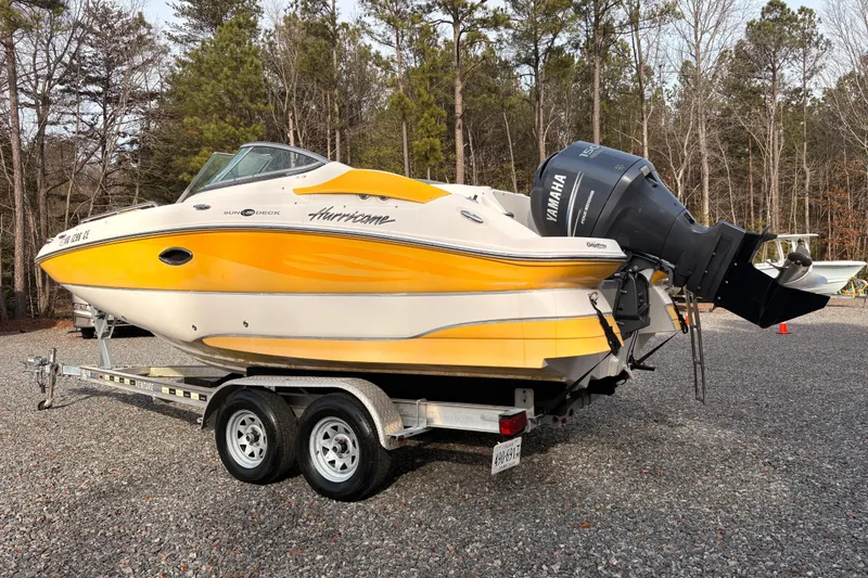 Slide: The Image of 2008 Hurricane SunDeck 2000 OB boat on trailer, yellow and white design, Yamaha engine. - 1