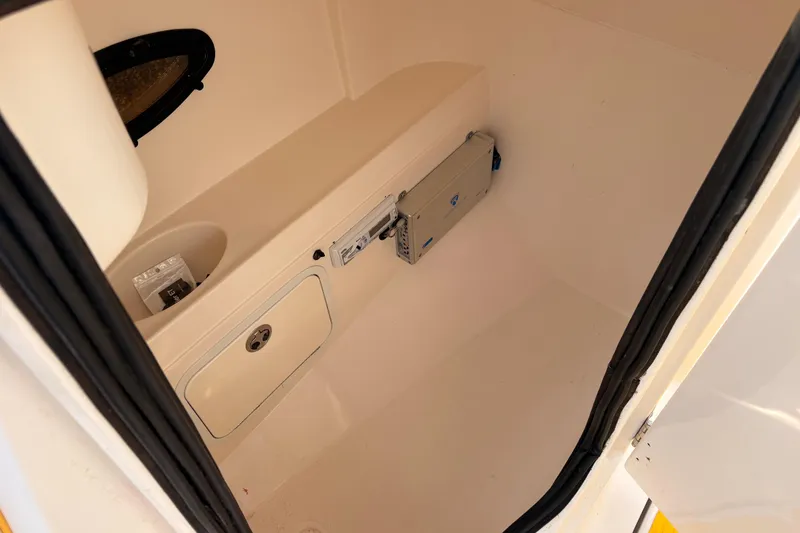 Slide: The Image of Interior of 2008 Hurricane SunDeck 2000 OB boat, featuring storage compartment and equipment. - 10