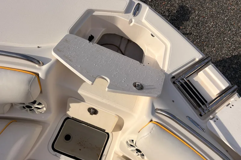 Slide: The Image of 2008 Hurricane SunDeck 2000 OB boat interior with seating, storage, and ladder. - 13