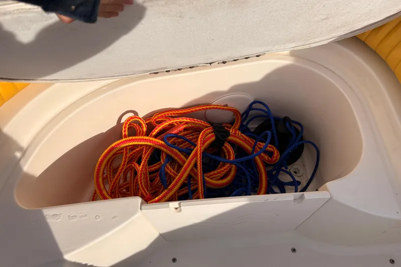 Slide: The Image of Storage compartment with colorful ropes on a 2008 Hurricane SunDeck 2000 OB boat. - 14