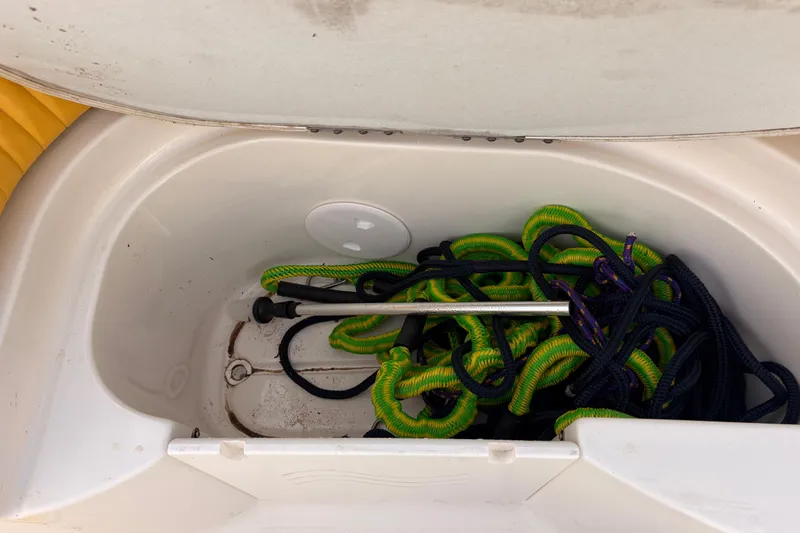 Slide: The Image of Storage compartment of 2008 Hurricane SunDeck 2000 OB boat with ropes and equipment. - 15