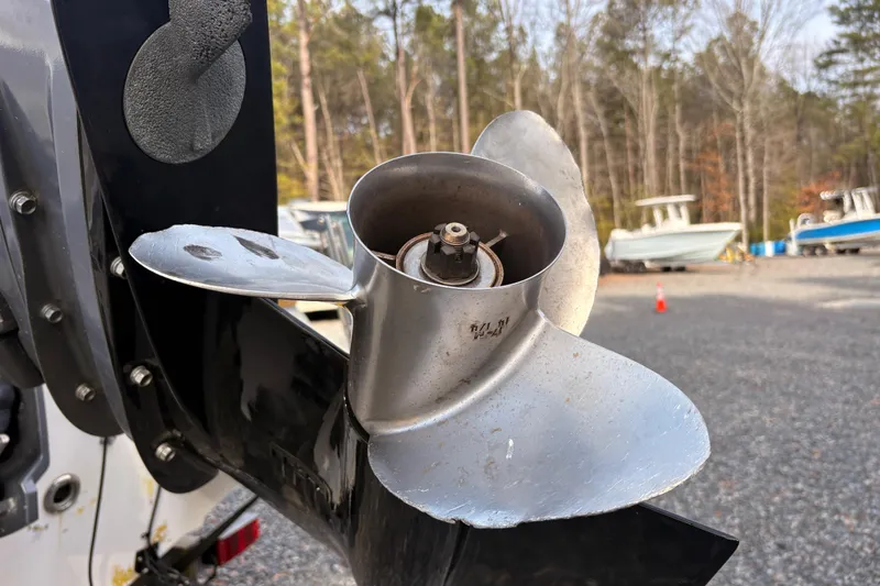 Slide: The Image of Close-up of a 2008 Hurricane SunDeck 2000 OB boat propeller in a marina setting. - 2