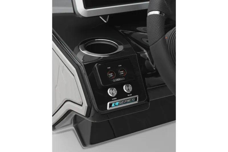 Slide: The Image of 2025 Yamaha Boats 252XE dashboard with controls and cup holder. - 11