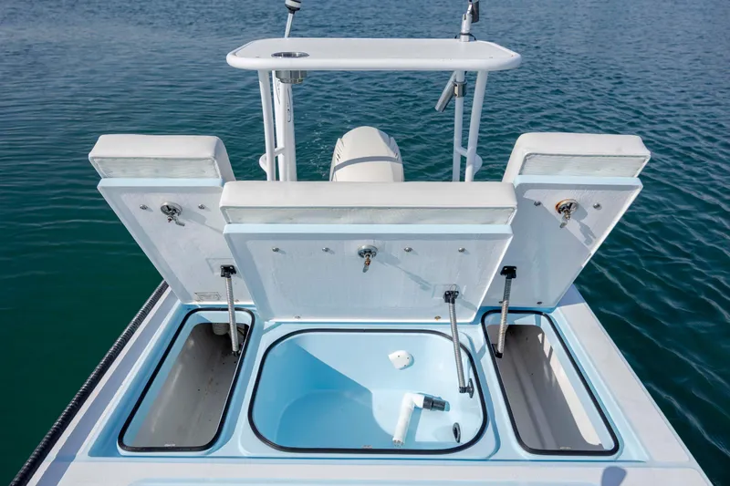 Slide: The Image of 2015 East Cape Fury boat with open storage compartments on calm water. - 12