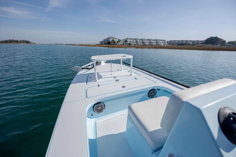 Slide: The Image of 2015 East Cape Fury boat on calm water with scenic shoreline view. - 15