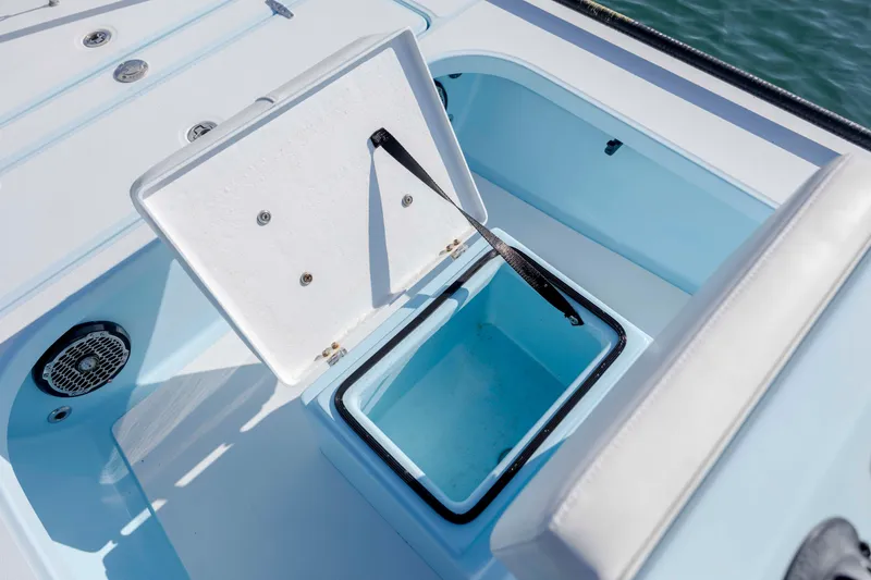 Slide: The Image of Open storage compartment on 2015 East Cape Fury boat, featuring light blue interior. - 18