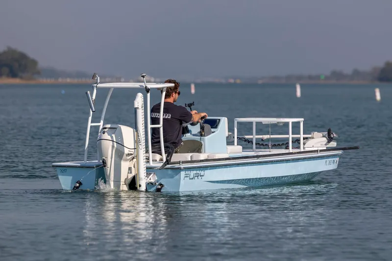 Slide: The Image of 2015 East Cape Fury boat on calm water, operated by a person. - 7