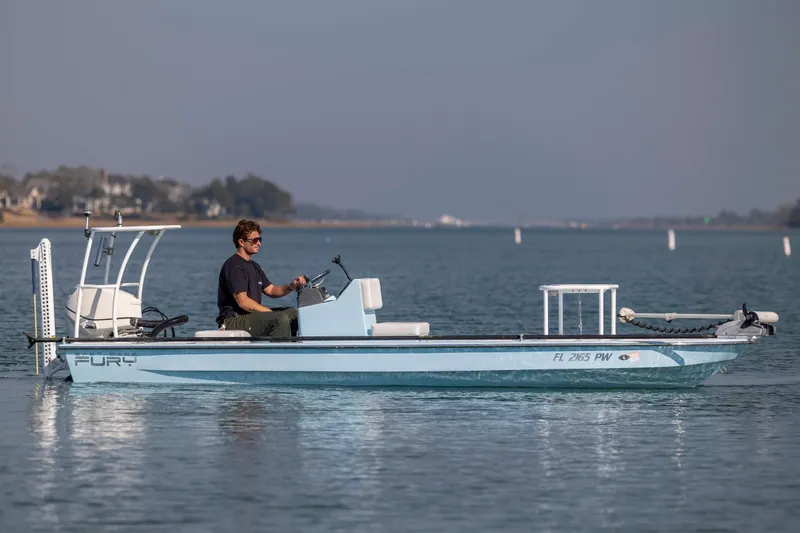 Slide: The Image of 2015 East Cape Fury boat on calm water with a person steering. - 8
